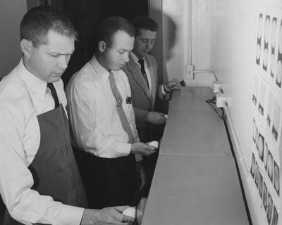 1957 Poultry Team; From left to right: Carl Corbin, Leon Davis, Gene Holtzclaw get practice grading eggs