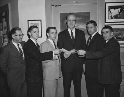 Dairy majors at the University of Kentucky receive $100 scholarship checks from Dr. D. M. Seath, head of the University of Kentucky Dairy department; From left to right are: Dr. T. R. Freeman, Charles Cornett, Clay County; Kenneth Whitis, Somerset; Dr. Seath; Ellis Green, Bridgeport; Kenneth Evans, Flemingsburg