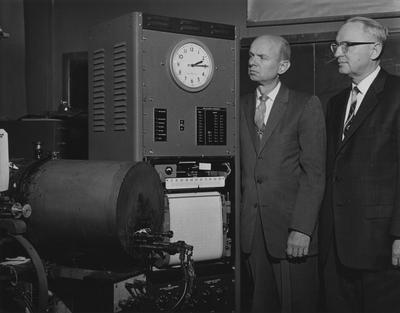 Research equipment is inspected by Dr. Hartley C. Eckstrom (left), professor of Chemistry, and Dr. Lyle R. Dawson, head of the department