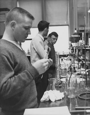 Four men performing experiments