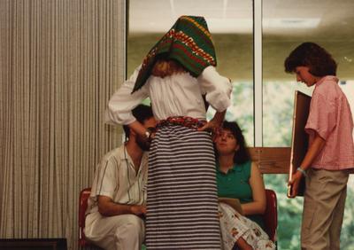 Tony Houston (left) judges two female students at the Foreign Language Festival, which was held in the Student Center on the University of Kentucky campus