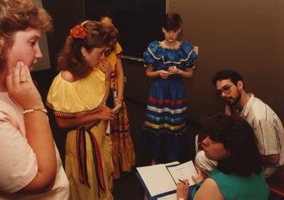 Tony Houston (left) judges female students at the Foreign Language Festival, which was held in the Student Center on the University of Kentucky campus