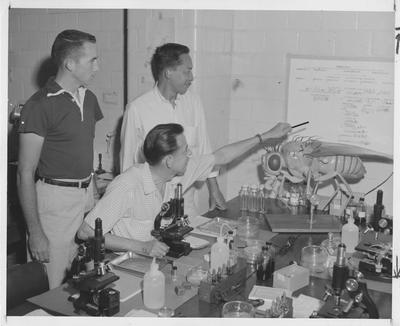 Dr. John Carpenter (seated) and two unidentified men in a Zoology lab