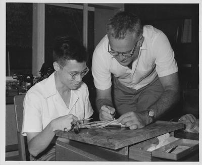Roger W. Barbour (right), associate professor of Zoology, helps Karl P. Liem, University of Indonesia graduate student, dissect a tropical eel; Professor Barbour was one of 16 American technicians working at the University of Indonesia's Technical and Science Faculties (colleges) in Bandung under an ICA financed contract with the University of Kentucky