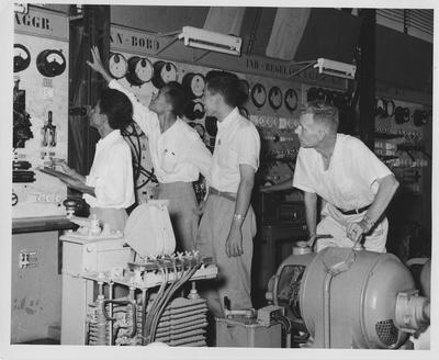 Charles N. Loar (right), associate professor of Electrical Engineering, supervising an experiment in the University of Indonesia's Electrical Engineering laboratory; Professor Loar was one of 16 American technicians working at the University of Indonesia's Technical and Science Faculties (colleges) in Bandung under an ICA financed contract with the University of Kentucky