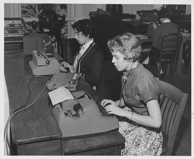 Helen Shuck (back turned) in a typing class