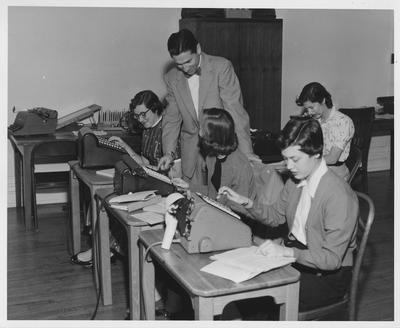 A class of women learning to use adding machines; Helen Shuck, Kathy Stafford, unidentified, and Ann Shirley (back)