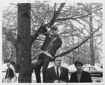 Larry Kielkoph, photographer for the Kentuckian, seated in a tree; This photo is in the 1969 Kentuckian on page 444, image 1