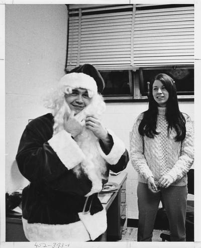 Tom Deer, the Kentucky Kernel Business Manager, is dressed up like Santa Claus ; This image is in the 1969 Kentuckian on page 393, image 1