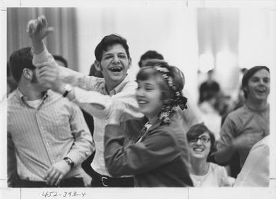The man with his hands in the air is David Herman, the photographer of the Kentucky Kernel, with a group of students; This image is in the 1969 Kentuckian on page 393, image 4
