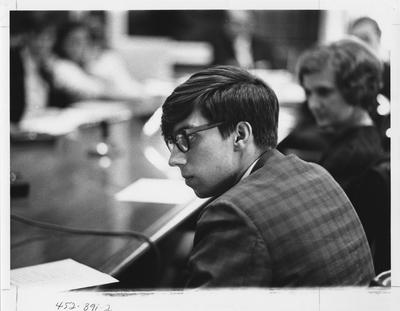 Becker (with glasses), editor of the Kentucky Kernel, is seated at a table with others; This image is in the 1969 Kentuckian on page 391, image 2
