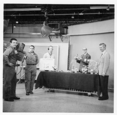 Dr. Charles Snow, second from right, showing primate exhibits during an Anthropology 100 course taught on television