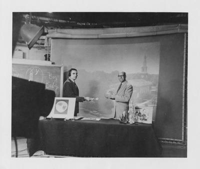 Dr. Charles Snow, right, on television teaching his Anthropology 100 course
