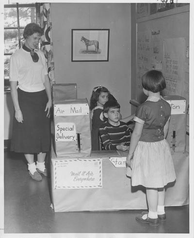 A second grade class is demonstrating what it is like at the Post Office; Photographer: Ted W. Simmons
