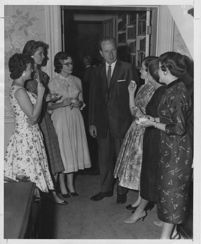 Dean Martin Leslie, professor of Higher Education and Dean of men, stands amongst a group of women; Photographer: Ted W. Simmons