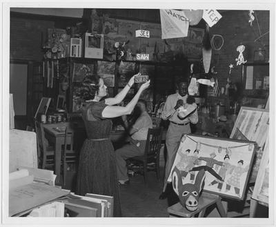 An art class; From left to right: Sally Johnson, Paul Johnson (back), and Charles Houston