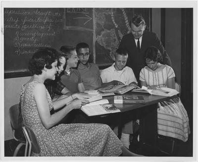 Students look at textbooks