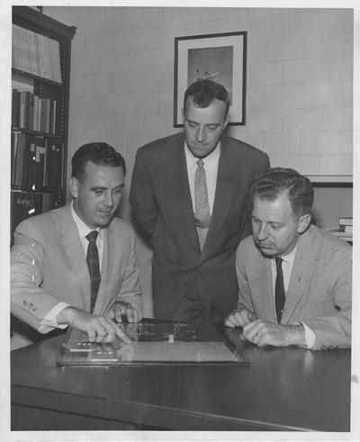 A research contract awarded to the University of Kentucky by International Business Machines Corporation is discussed by, from left: C. L. Reardon, representing I. B. M.; O. W. Gard; and Dr. Merle Carter, of the University of Kentucky, head of the project