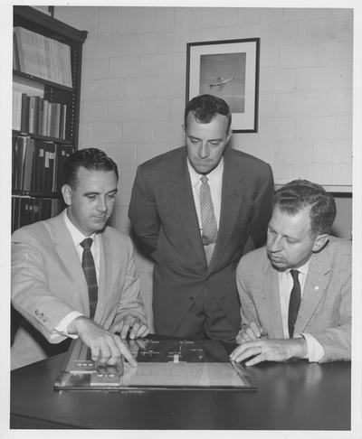 A research contract awarded to the University of Kentucky by International Business Machines Corporation is discussed by, from left: C. L. Reardon, representing I. B. M.; O. W. Gard and Dr. Merle Carter, of the University of Kentucky, head of the project