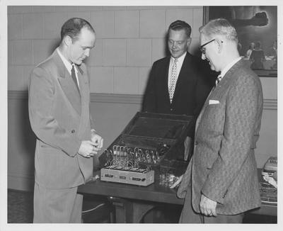 Dr. H. A. Romanowitz (right), head of the University of Kentucky Department of Electrical Engineering, with I. B. M. officials Henry W. Simpson (left), an electrical engineer who holds both a B. S. and M. S. from the University of Kentucky, and Walter O. Cralle, manager of Development Engineering for I. B. M.; University of Kentucky received equipment donated by I. B. M