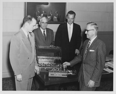 Dr. H. A. Romanowitz (right), head of the University of Kentucky Department of Electrical Engineering, with I. B. M. officials Henry W. Simpson (left), an electrical engineer who holds both a B. S. and M. S. from the University of Kentucky, and Walter O. Cralle, manager of Development Engineering for I. B. M.; University of Kentucky received equipment donated by I. B. M