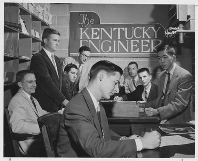 William Lowry in the foreground; and from left to right: Robert Adams, John Dressman, Barry Johnson, James Cooper, Cecil Isbell, James Hummeldorf, and David Cheng; This image is on page 289 of the 1958 Kentuckian