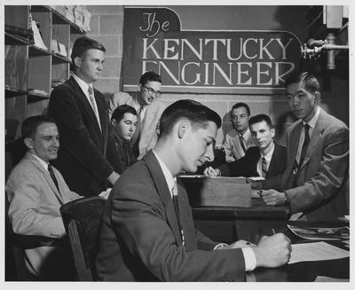 William Lowry in the foreground; and from left to right: Robert Adams, John Dressman, Barry Johnson, James Cooper, Cecil Isbell, James Hummeldorf, and David Cheng; This image is on page 289 of the 1958 Kentuckian, picture number 1