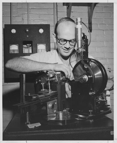 Cullie Sparks, Jr., candidate for the degree of doctor of engineering and principal investigator for a University of Kentucky research project carried on for the Air Force, is shown here in a metallurgical laboratory; He is pictures with part of a Geiger counter spectrometer used to examine the internal structure of titanium