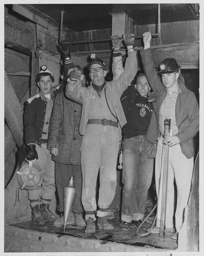 Professor William H. Roll gives instructions to an elevator operator as part of the class arrives 265 feet below ground level at the Central Rock Company limestone mine; From left to right: James R. Gray, Jenkins; Robert A. Elan, Barbourville, partly hidden; Professor Roll; Tom Cambron, Henderson; and James Irvine, Colleville, Pennsylvania