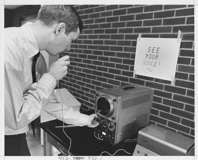 Student uses equipment for sound recognition; This image is on page 382 of the 1969 Kentuckian