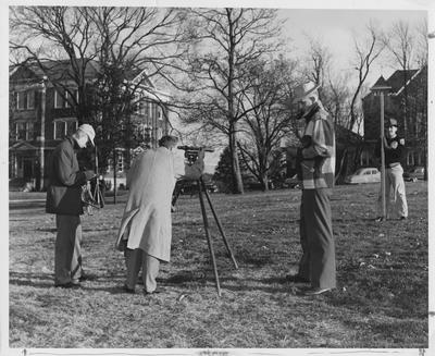 Men using surveying equipment