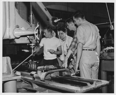 Men using a drill press
