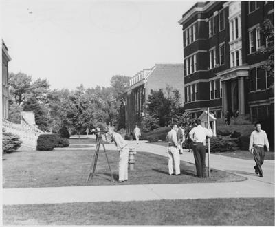 Men surveying in front of Pence Hall
