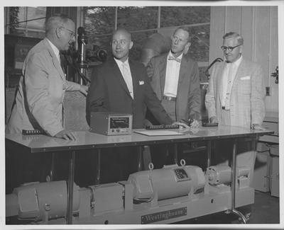 Men viewing a Westinghouse Torque meter; Dean Shaver on left