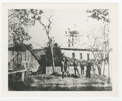 Unidentified men in front of building with construction