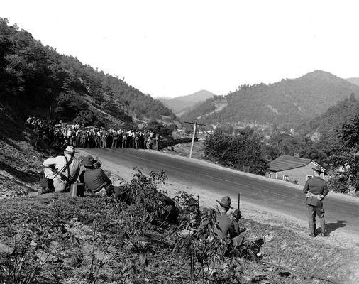 National Guardsmen watching a crowd of miners blocking a road