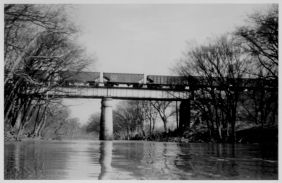 Coal cars on a train crossing a bridge