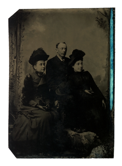 Group portrait of two women and a man, all unidentified