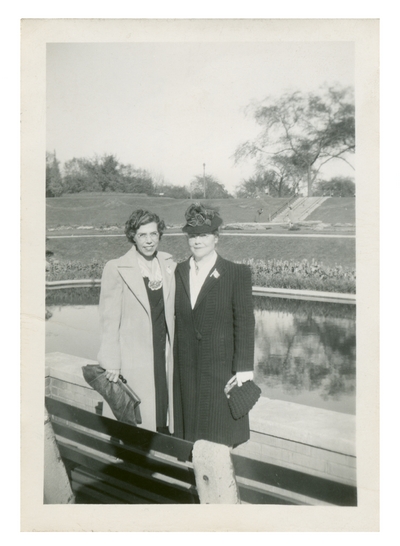 Irene and an unidentified woman standing outside.  Handwritten on verso, 