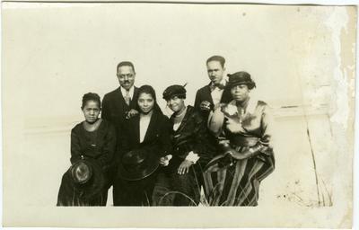 Unidentified group photo of four African American females and two African American males on the beach; same individuals pictured in item 105