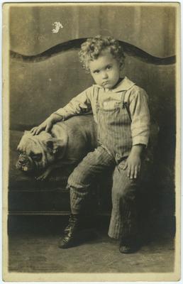 Unidentified male child and dog