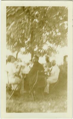 Unidentified African American men and women sitting at a table