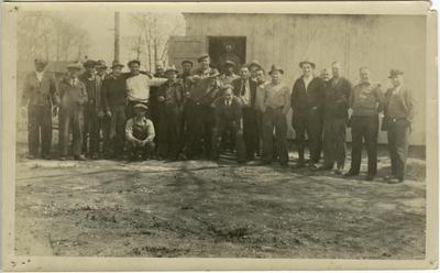 William Green and unidentified males posing in front of a building