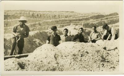 William Green and unidentified males posing in a ditch