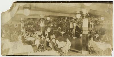 African Americans seated in a decorated banquet hall; written on the picture 