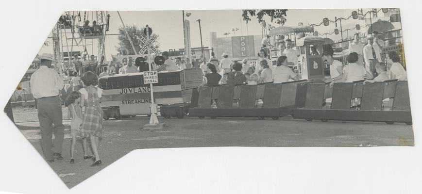 People sitting in rows being pulled by a small Joyland Steamliner train car, amusement attraction, Joyland Park - stamped on back of photograph MACK HUGHES PHOTOGRAPH 503 E. HIGH LEXINGTON, KY
