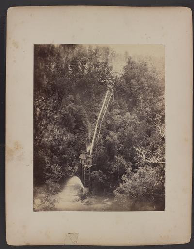 Landscape; steam powered pump house from #13 above in center, surrounded by trees, creek in foreground, trees and clearing in background