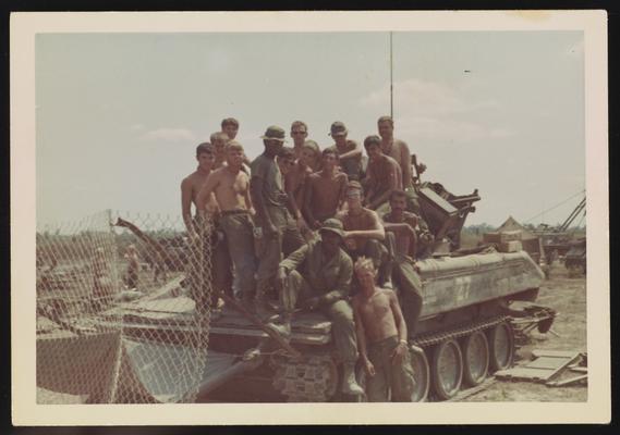 Soldiers posing on armored personnel carrier