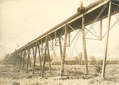 Barrels on the edge of High Bridge-train on railroad tracks below