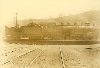 Cincinnati, New Orleans, & Texas Pacific #810 -train carrying pile of bricks and rocks on railroad tracks